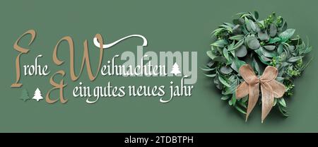 Text FROHE WEIHNACHTEN END GUTES NEUES JAHR (German for Merry Christmas and Happy New Year) and mistletoe wreath on green background Stock Photo