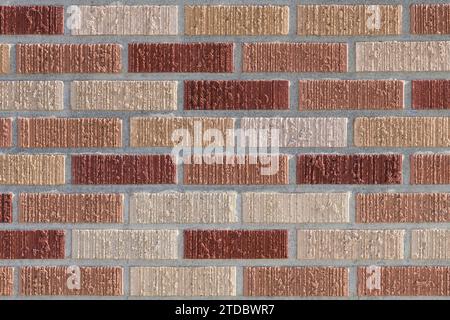 Modern wall of thin red bricks with vertical texture in closeup Stock Photo