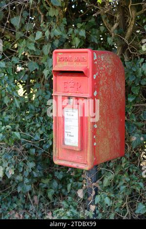 Shawbury, UK - March 7, 2023; Rural red Royal Mail letter box with Queen Elizabeth Royal Cypher Stock Photo