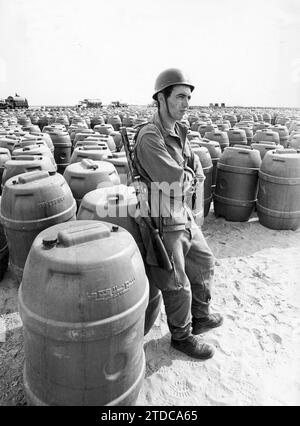 10/31/1975. A Moroccan soldier stands guard in front of the Thousands of Barrels of water that are intended to satisfy the needs of the Volunteers of the 'Green March'. The long walk of three hundred and fifty thousand people across the desert was threatened by the problem of water scarcity. The amount allocated to each participant seems insufficient. The Consequences Can Be Very Serious. Credit: Album / Archivo ABC Stock Photo