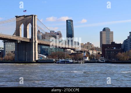 Brooklyn Bridge and riverside Brooklyn seen from Pier 17 in Manhattan, New York Stock Photo