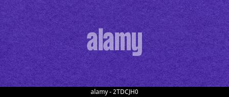 Texture of navy blue and dark violet colors paper background, macro. Structure of dense craft indigo cardboard. Felt backdrop closeup. Stock Photo