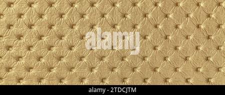 Texture of golden leather background with capitone pattern, macro. Yellow textile of retro Chesterfield style. Vintage fabric backdrop. Stock Photo