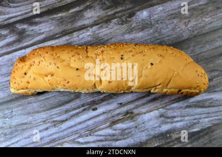 Long sesame and black Baraka seed bun bread, fresh baked loaf of bread French Fino ready to fillings, typically filled with savory fillings, made from Stock Photo