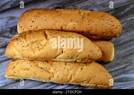 Long sesame and black Baraka seed bun bread, fresh baked loaf of bread French Fino ready to fillings, typically filled with savory fillings, made from Stock Photo