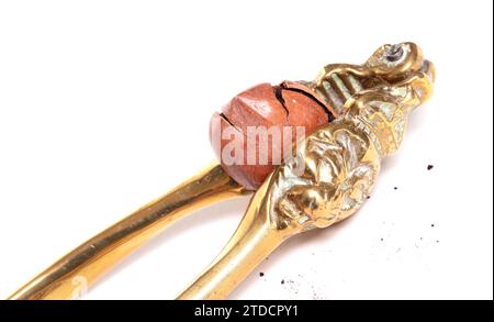 Large nut with vintage nutcracker, isolated on white Stock Photo