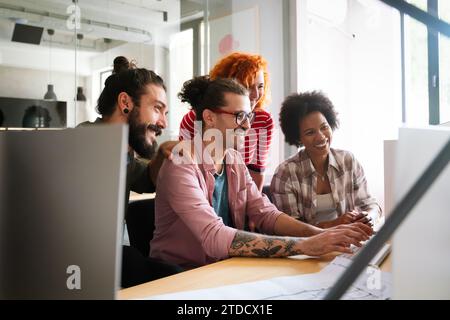 Mixed team of software engineers brainstorming ideas. Diverse app developers collaborating as group Stock Photo