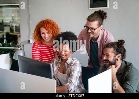 Mixed team of software engineers brainstorming ideas. Diverse app developers collaborating as group Stock Photo