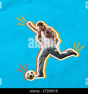 Excited and emotional young man in casual clothes hitting ball, playing football over blue background Stock Photo