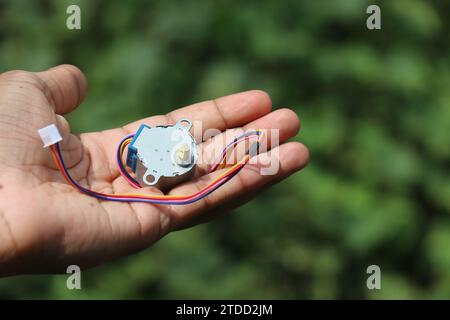 Stepper motor used in hobby electronic projects held in hand Stock Photo