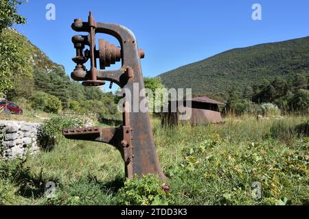 Vintage or Old Wood Clamp for holding logs or tree trunks & Rusty Cauldron in Derelict & Abandoned Sawmill at La Martre Var Provence France Stock Photo