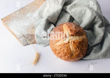 Freshly baked round bread with a crispy brown crust. Stock Photo