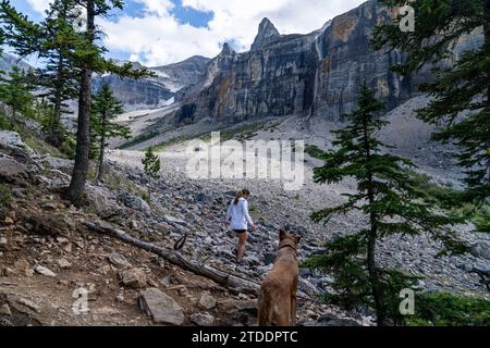 Girl Walking Her Dog Through Canadian Rockies Stock Photo