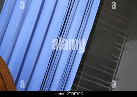 A blue curtain with dark background. Stock Photo