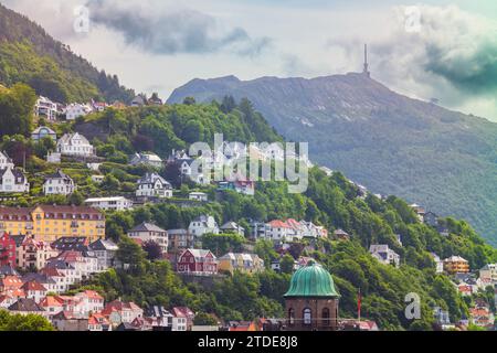Homes and businesses built on the side of a mountain, photographed during a summer afternoon at the city of Bergen, Norway. Stock Photo