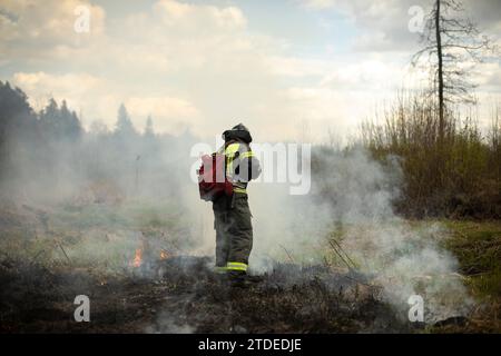 A firefighter puts out a fire in a residential neighbourhood following ...