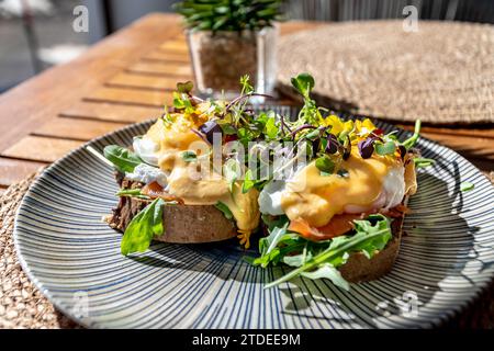 a close up image of grilled toast topped with eggs benedict in a mediterranean restaurant. Stock Photo