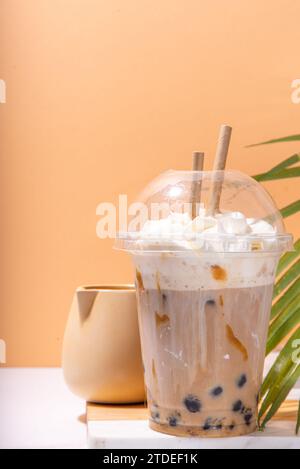 Tapioca boba balls coffee frappe, asian trendy cold coffee drink with tapioca balls and whipped coconut cream and caramel sauce Stock Photo