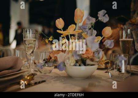 Elegant, romantic table setting for indoor spring wedding reception. Luxury wedding table decoration, special event table set up with fresh spring Stock Photo