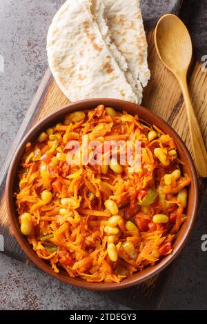 South African vegetable relish or side dish called Chakalaka closeup on the bowl on the table. Vertical top view from above Stock Photo