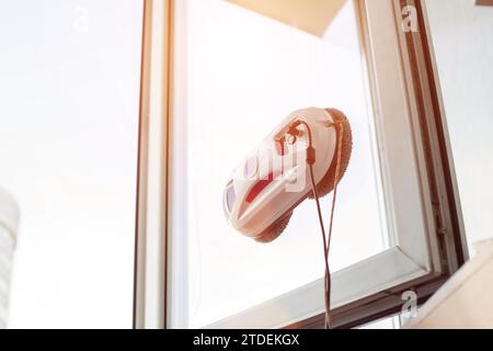Clean windows safely with a window cleaning robot. Stock Photo