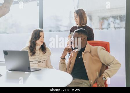 Colleagues collaborating on project details in a creative office. Analyzing market research, sharing ideas for business growth and profitability. Stock Photo