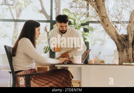 Multigenerational coworkers discuss project details, collaborate in office for business growth and profitability. Stock Photo
