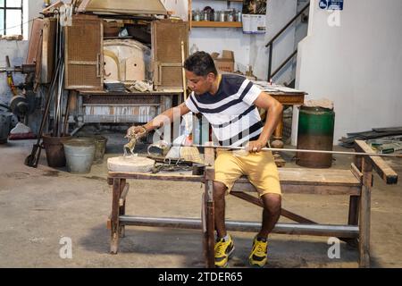 Murano, Italy - June 22, 2023: Inside a Murano glass factory, a master glassmaker demonstrates the glass product-making process. Stock Photo