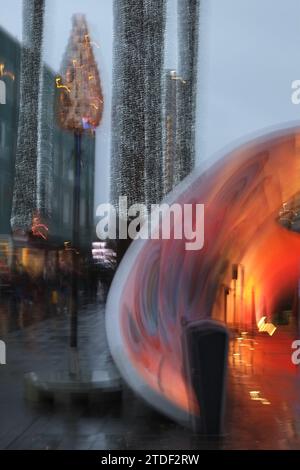 Blurred skyline seen from a city centre square in Eindhoven with colourful lights Stock Photo