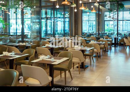 Interior of an empty restaurant hall with large windows. Stock Photo