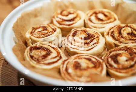 Fresh homemade raw Cinnamon rolls prepared for baking. Stock Photo