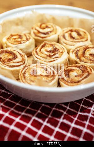 Fresh homemade raw Cinnamon rolls prepared for baking. Stock Photo