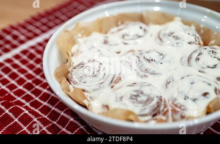 Freshly baked cinnamon rolls with cream cheese. Stock Photo