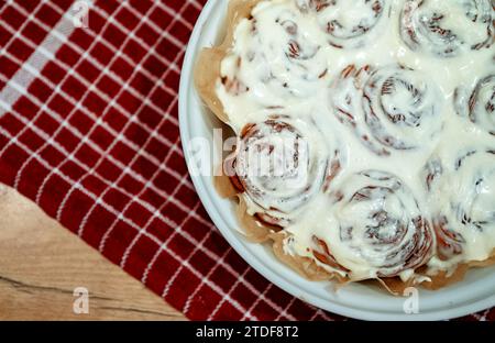 Freshly baked cinnamon rolls with cream cheese. Stock Photo