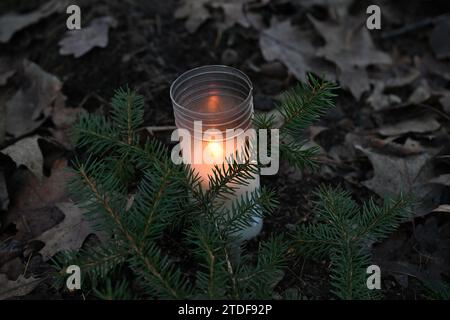 Prague, Czech Republic. 18th Dec, 2023. A candle near the crime scene of the double murder at Klanovice Forest, Prague, Czech Republic, pictured on December 18, 2023. Two people, one of them a child, were found dead in the Klanovice neighbourhood on the eastern outskirts of Prague on December 15, 2023. Several dozen police officers are working to solve the double murder. Credit: Michaela Rihova/CTK Photo/Alamy Live News Stock Photo
