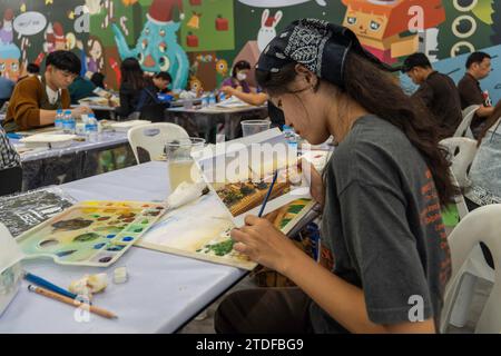 A participant is seen reproducing an image with watercolor painting, at the “BEM Art Contest' watercolor painting contest, at MRT Phahon Yothin station. The “Metro Art” at the MRT Phahon Yothin, developed by Bangkok Expressway and Metro Public (BEM), Bangkok Metro Networks Limited (BMN), and supported by the Tourism Authority of Thailand (TAT) is the new Art Space and Art Destination in the city's heart as the MRT Phahon Yothin station connects to all areas of Bangkok, where visitors can learn arts in various fields, shop and sell works of art. Stock Photo