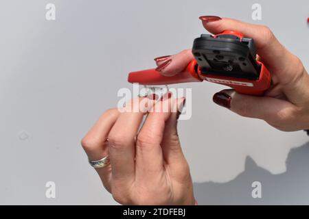 Crimping cable terminals with a tool Stock Photo