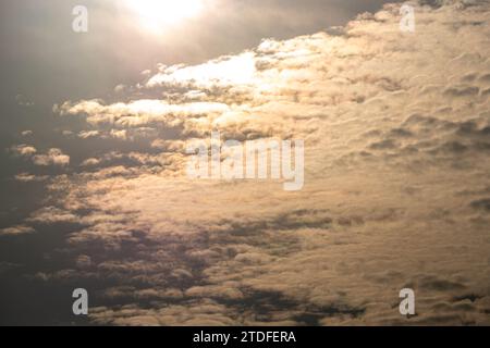 Fluffy gray clouds floating scattered across the sky at sunrise Stock Photo