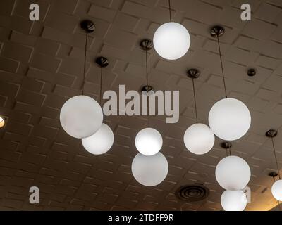 Round lamp, hanging alternating high and low, decorating the ceiling Stock Photo