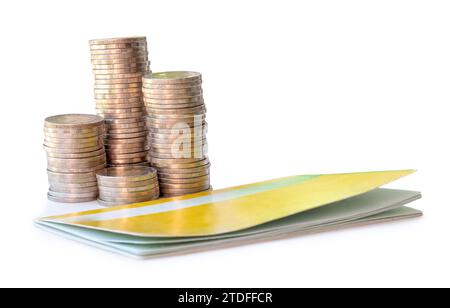 Silver coins in separated stacks with bank book are isolated on white background with clipping path. Money growth concept in investment and saving Stock Photo