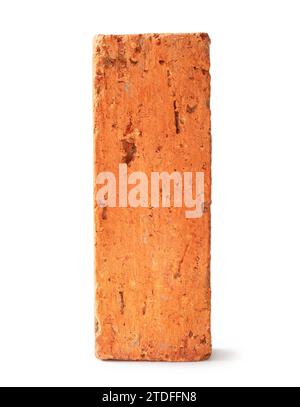 Single cracked old red or orange brick is isolated on white background with clipping path. Stock Photo
