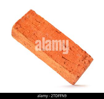 Single cracked old red or orange brick is isolated on white background with clipping path Stock Photo