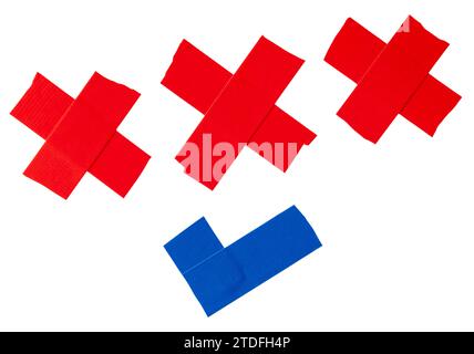 Set of red and blue scotch tape or adhesive vinyl tape in stripe of cross and check mark are isolated on white background with clipping path. Stock Photo