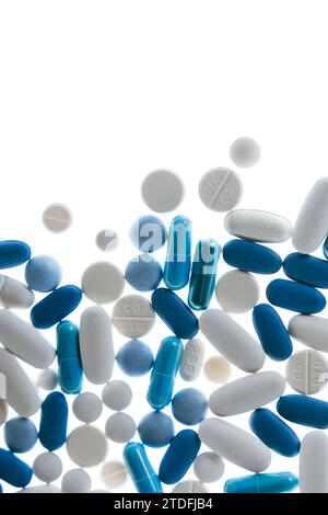 Blue and white pills and tablets against white background Stock Photo