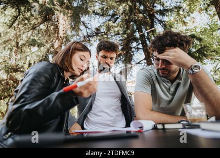 A business team discusses strategy and budget management at a coffee bar in the city area, aiming for business growth and success. Stock Photo
