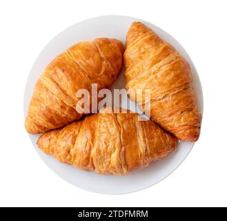 Appetizing croissants in white plate are isolated on white background with clipping path. Top view Stock Photo
