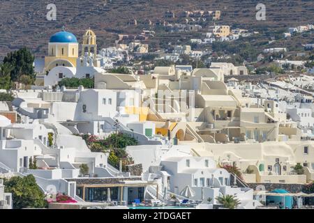 Summer Greece. Sunny day in the Santorini caldera. White hotel buildings on the terraces of Oia Stock Photo