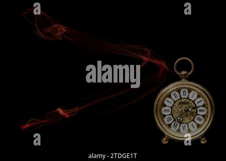 an old golden analog alarm clock with mechanical movement isolated on colored background Stock Photo