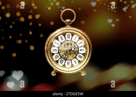 an old golden analog alarm clock with mechanical movement isolated on colored background Stock Photo