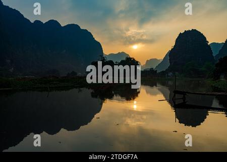 The Landscape of Ninh Binh with the Caves of Tam Coc and Trang An at sunset Stock Photo
